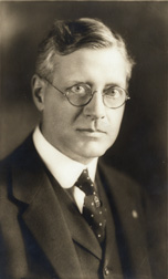 James Parker Hall wears wire-framed glasses, suit, tie, and vest. In black and white.