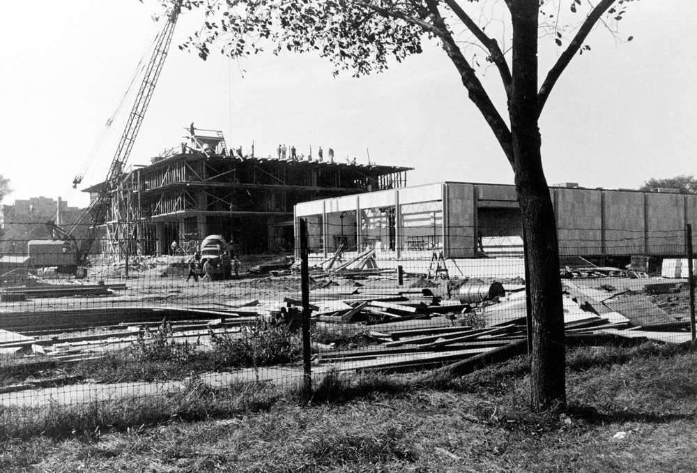 The Law School building under construction. Three floors are partially built with worker on the top.