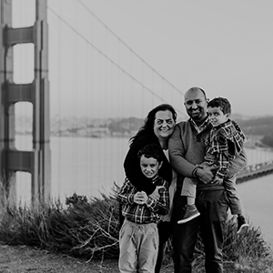 Nik and Molly with their children in front of a bridge.