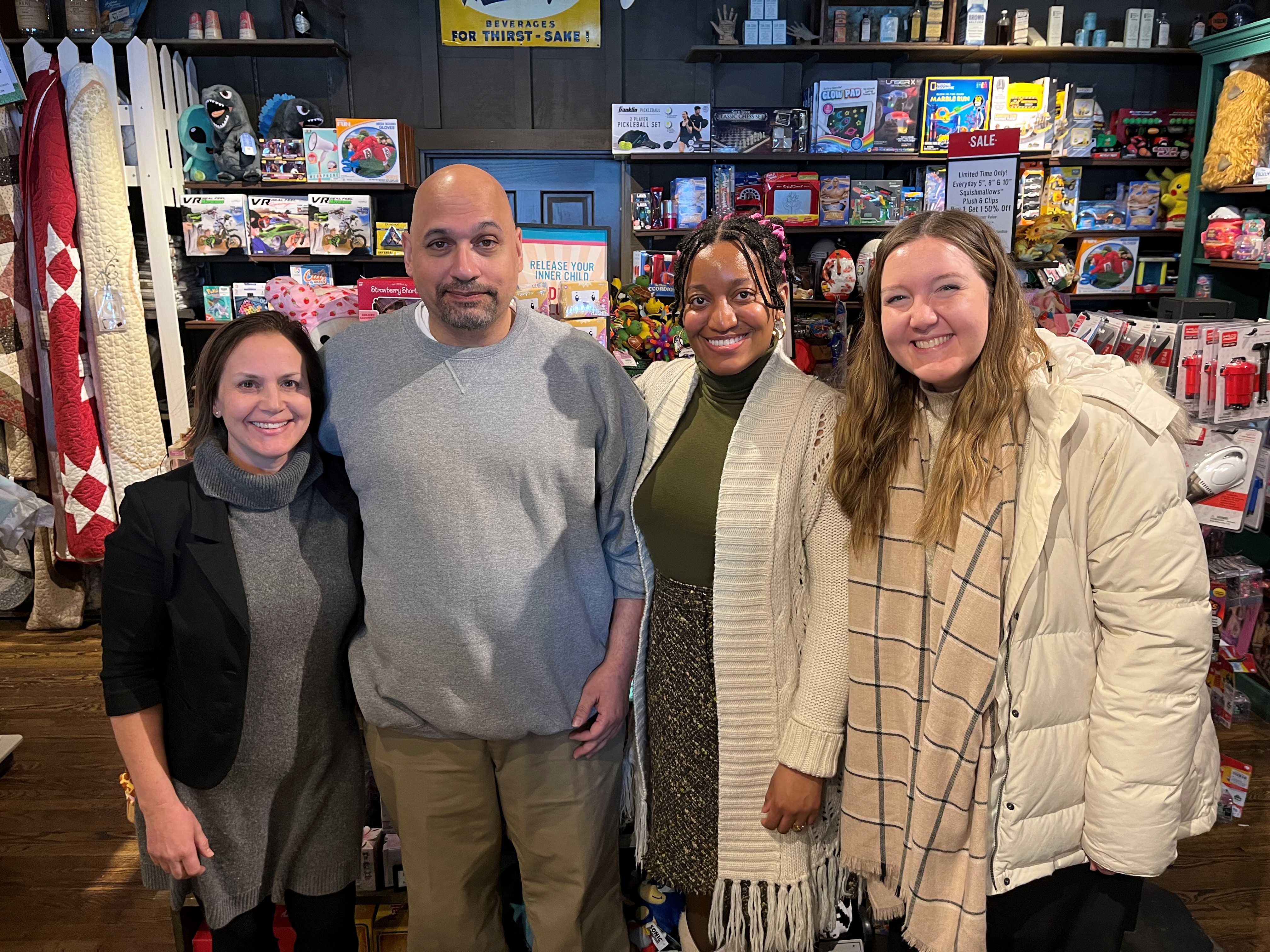 Erica Zunkel standing side by side with Robin Peoples and two female students.