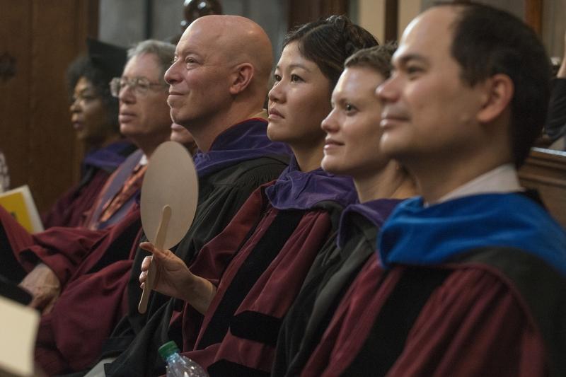 Members of the faculty enjoy the speeches at the Diploma & Hooding Ceremony.