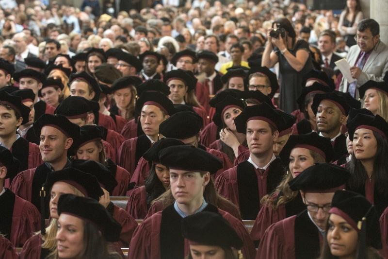 The Class of 2015 awaits receiving their hoods and diplomas.