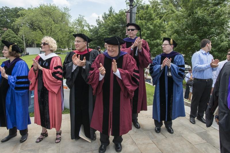 Faculty members congratulate the Class of 2015.