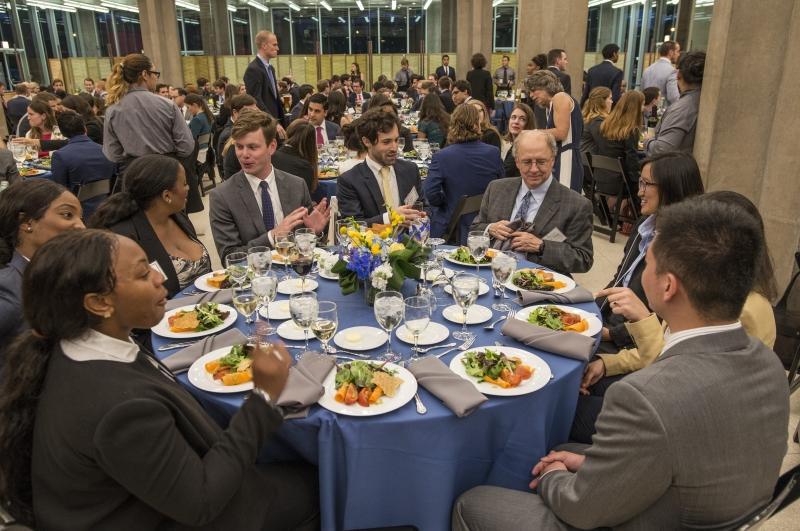 Inside, students enjoyed dinner and listened to a speech by William Baude, the Neubauer Family Assistant Professor of Law. This group is seated with Randal C. Picker, James Parker Hall Distinguished Service Professor of Law and the Ludwig and Hilde Wolf Teaching Scholar.