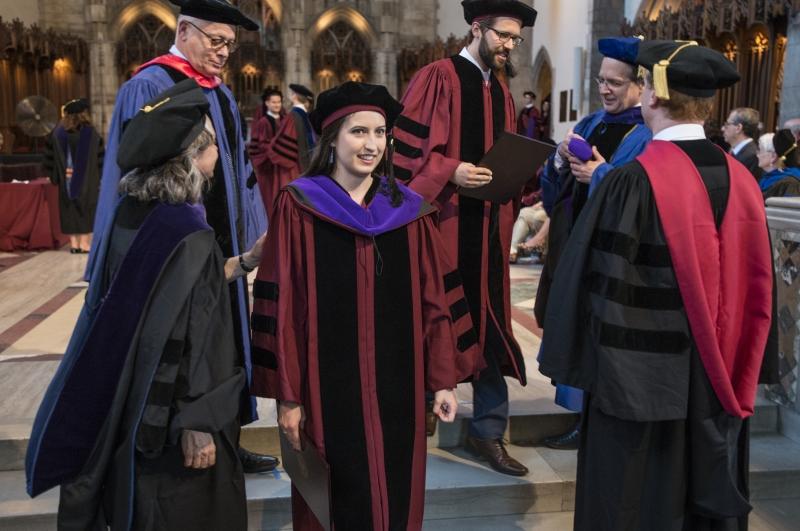 Carmel Dooling, '17, was hooded by Emily Buss, Mark and Barbara Fried Professor of Law, and Saul Levmore, William B. Graham Distinguished Service Professor of Law.