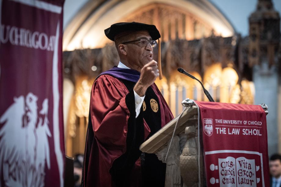 Barry Fields in cap and gown at podium at graduation ceremony.