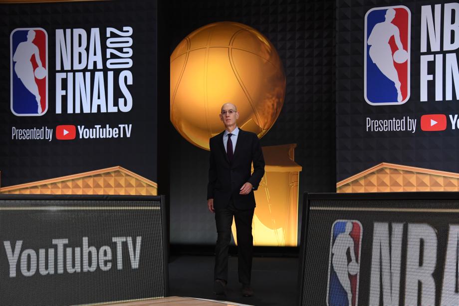 Adam Silver walks onto a stage.