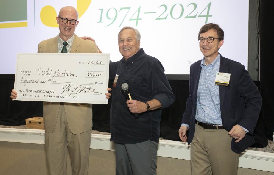 M. Todd Henderson with large blow-up of a $50,000 check