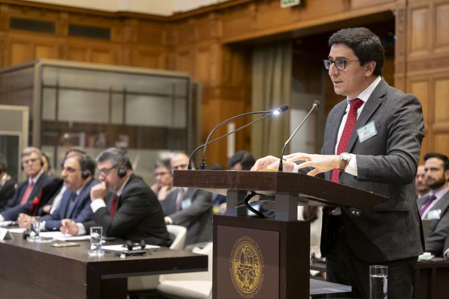 man standing behind podium