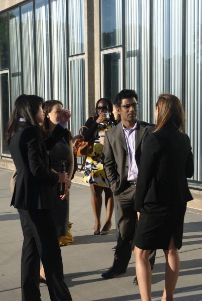 Professor Aziz Huq talks with students. 