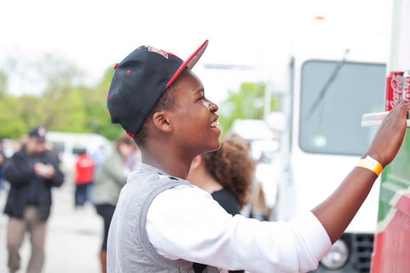 This young man bought from a truck with Italian food. 