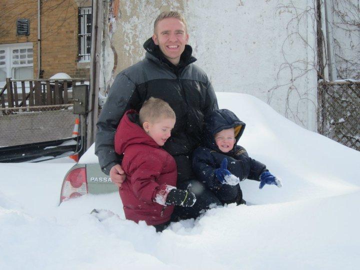 Chauncey Bratt '11 makes sure his sons Maxwell (3) and Jackson (1) don't get buried.