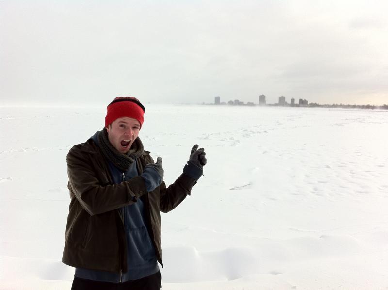 Alex Hartzler '12 shows off a frozen Lake Michigan with Indiana in the background.