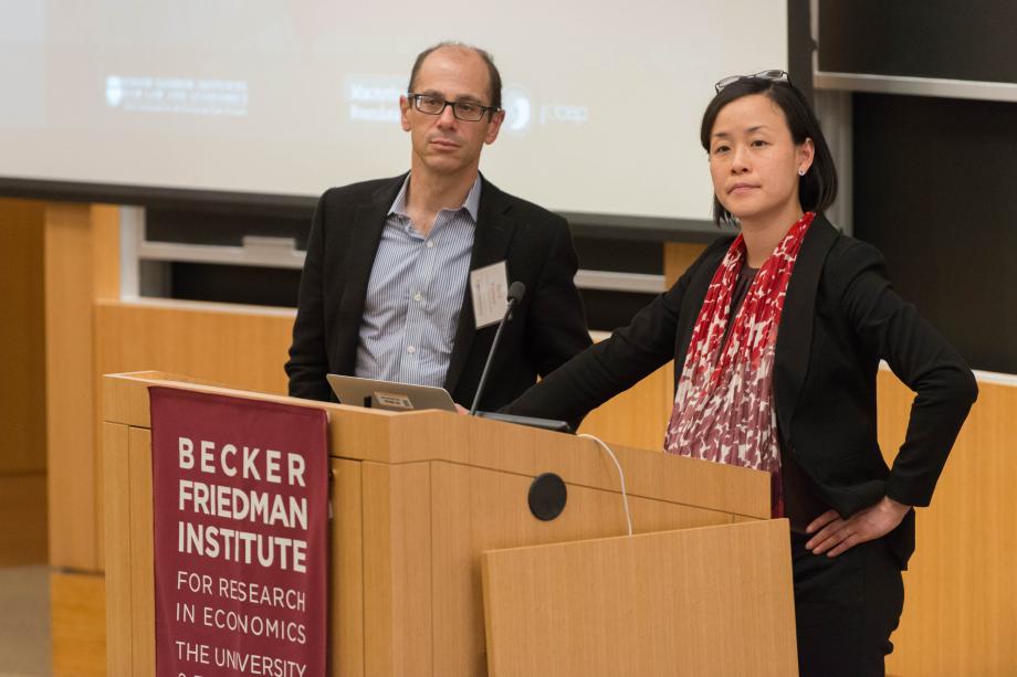 David Weisbach and Jennifer Nou stand at a lectern