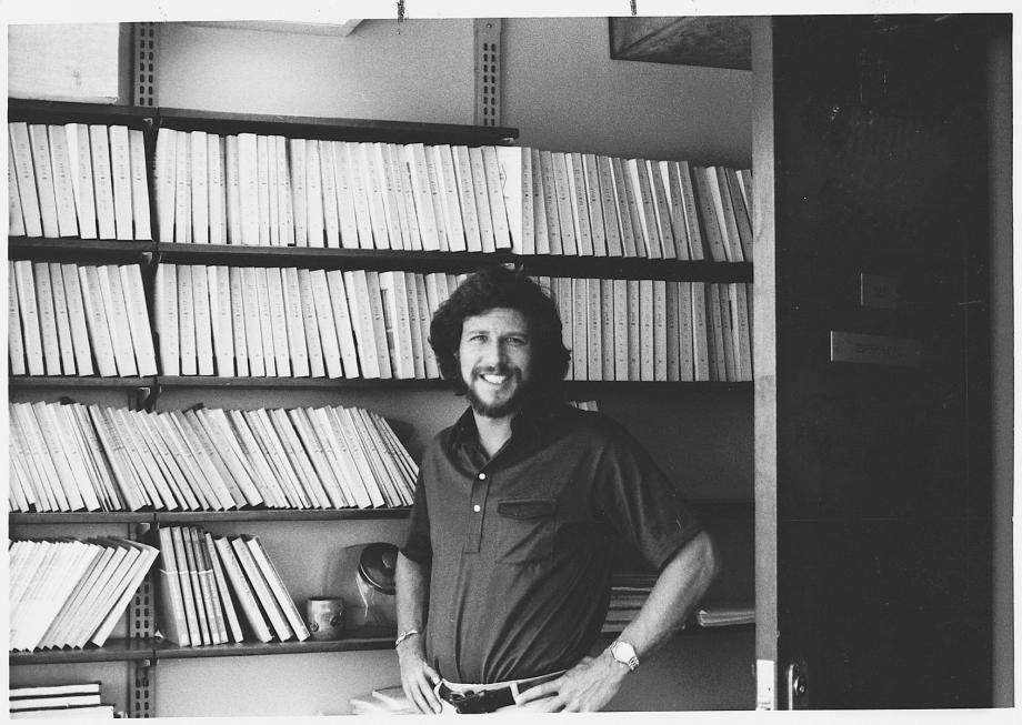 Stone, in a polo, smiles in his office in front of rows of issues of the Supreme Court Review.