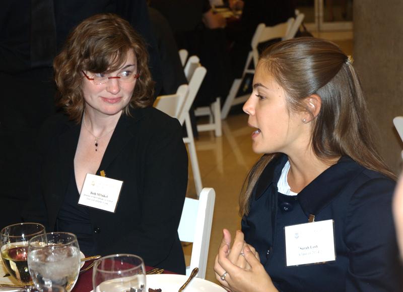 IJ Clinic Director Elizabeth Milnikel visits with a student at dinner.