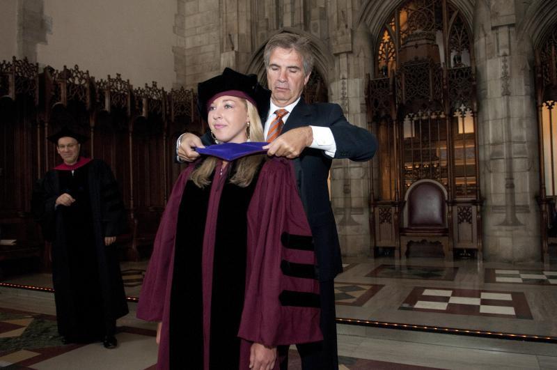 Some graduates were hooded by family members who were also alumni.