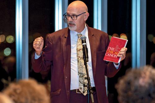 Professor Tom Ginsburg addressing audience and holding red book