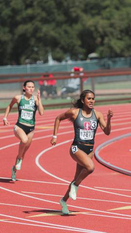 Megan Olomu running on a track.