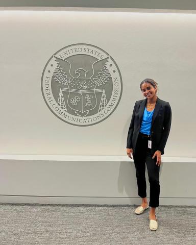 Megan Olomu in front of the Federal Communications Commission.