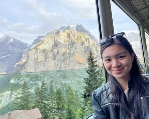 Margaret Lim smiles for the camera with a mountainous background.