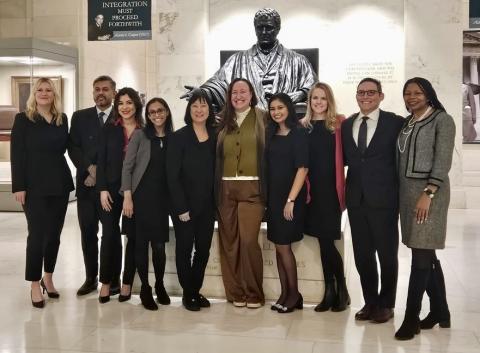 Fellows at the United States Supreme Court in front of a statute of Justice John Marshall