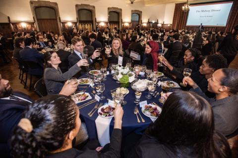 Students raise their glasses for a cheer.