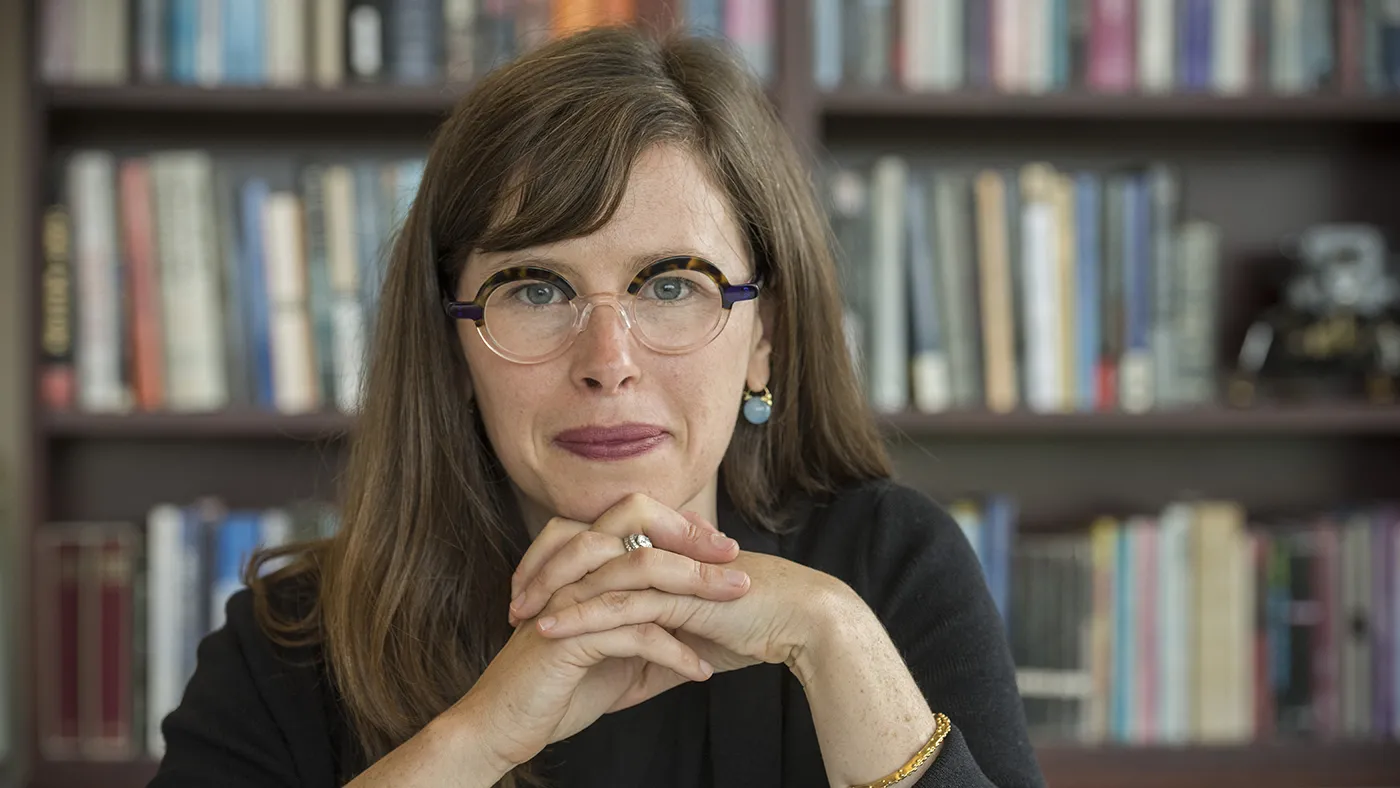 Bridget Fahey looks into the camera with her hands folded.